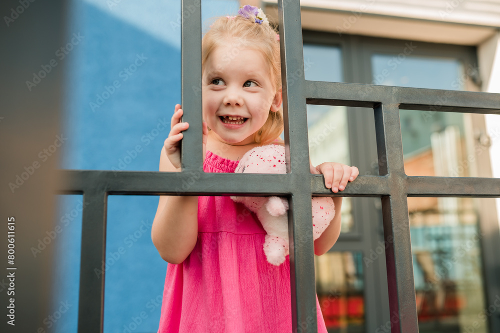 Happy cute child girl having fun outdoor in summer time. Children and generation alpha concept Happy cute child girl having fun outdoor in summer time. Children and generation alpha concept