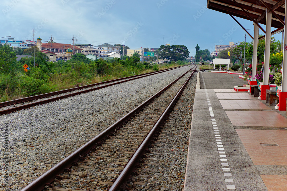 Countryside train station and long railway tracks Countryside train station and long railway tracks