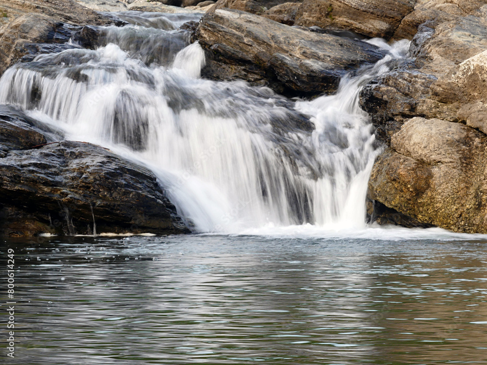 Fototapeta premium long shutter photography waterfall with rocks in the mountains