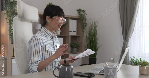 Mature japanese woman have a consultation via video call at office photo