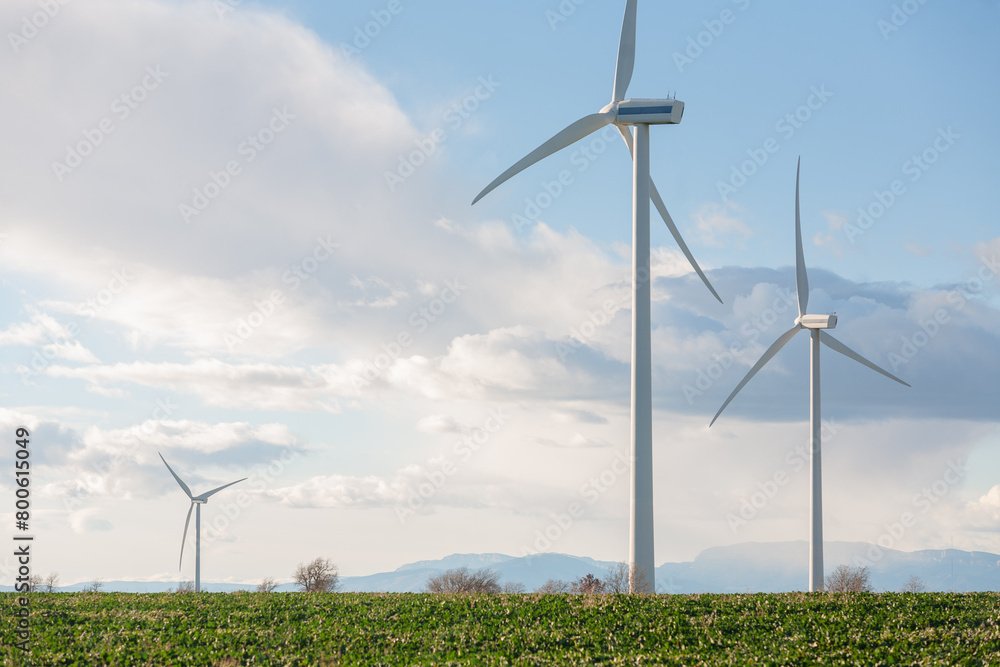 Three wind turbines are standing in a field Three wind turbines are standing in a field