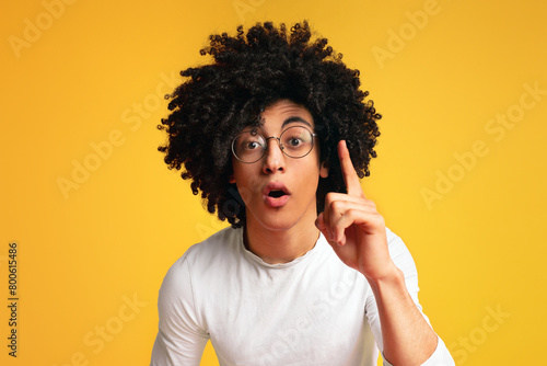 African-american man having idea, pointing with finger up
