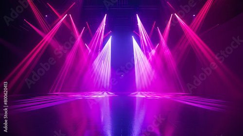 an empty stage illuminated by vibrant purple and pink lights. The lighting creates a dramatic and energetic atmosphere  with intense beams directed toward the center of the stage