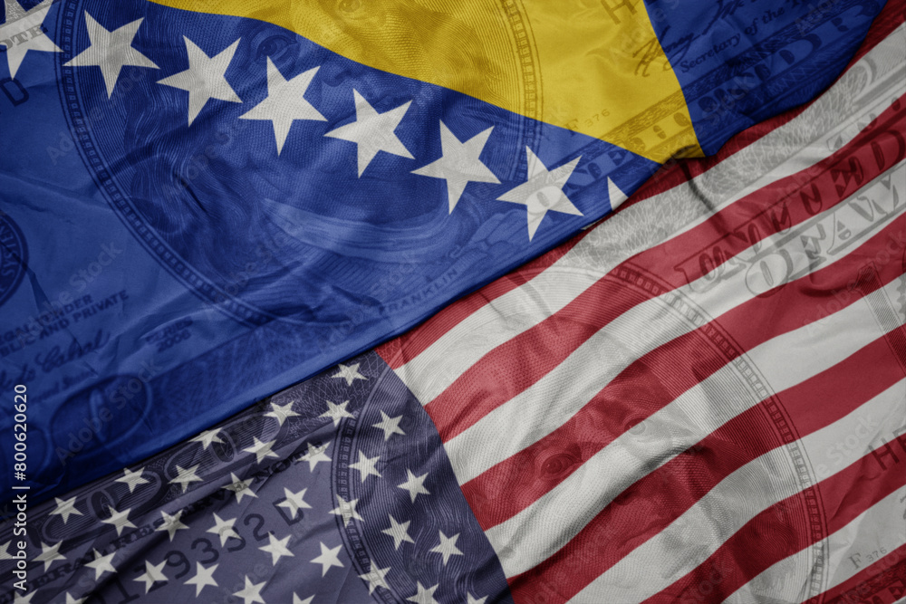 Obraz premium waving colorful flag of united states of america and national flag of bosnia and herzegovina on the dollar money background. finance concept.