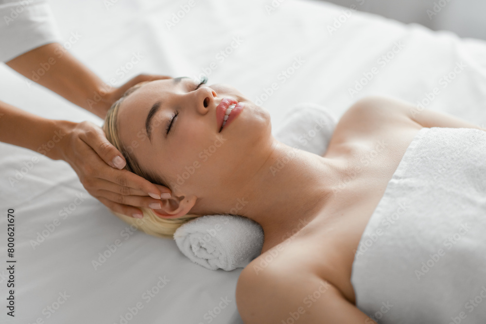 Young Woman Enjoying a Relaxing Head Massage Young Woman Enjoying a Relaxing Head Massage