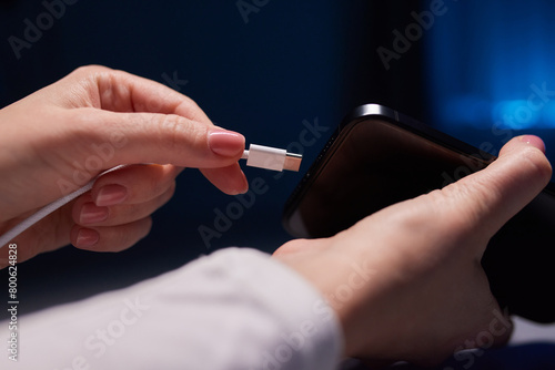 female Hand charges Charge your phone. Close up USB Type-C