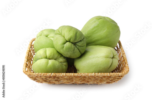 Fresh green chayote in wicker basket isolated on white