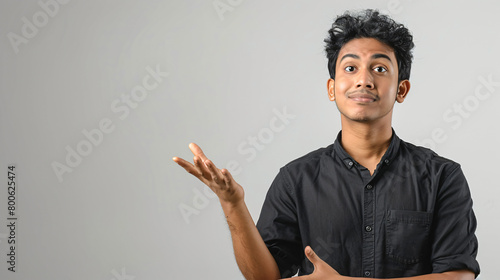 man pointing his hand away from his body and raising eyebrows photo