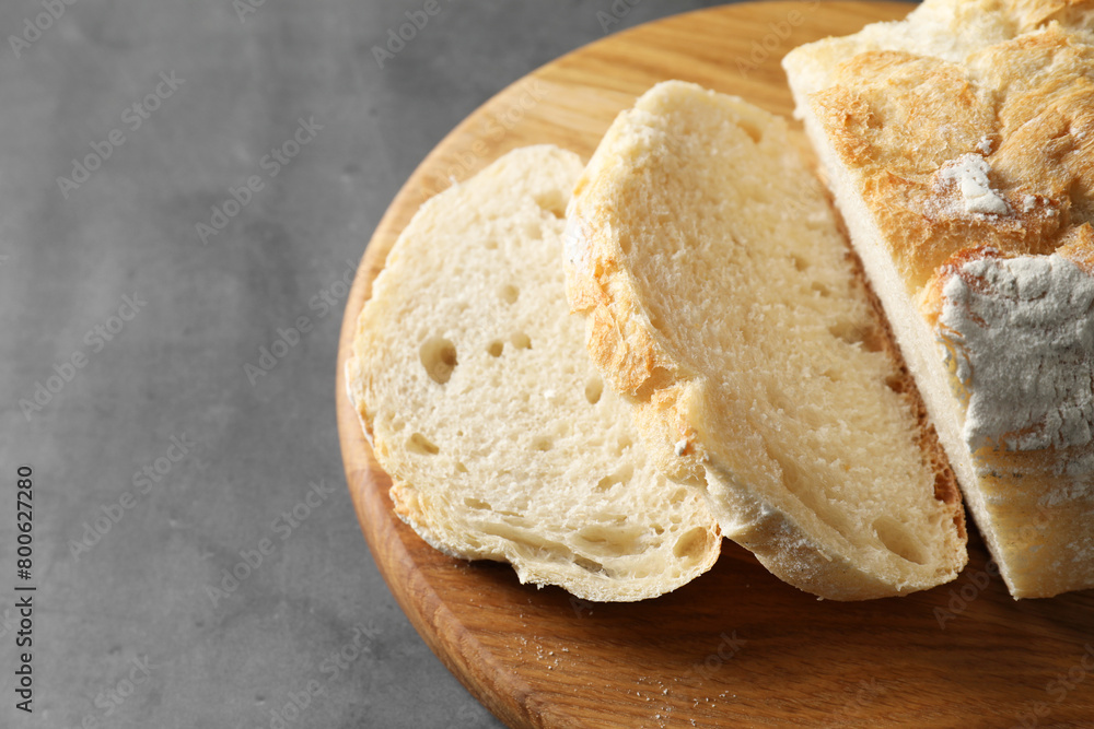 Freshly baked cut sourdough bread on grey table, closeup. Space for text Freshly baked cut sourdough bread on grey table, closeup. Space for text