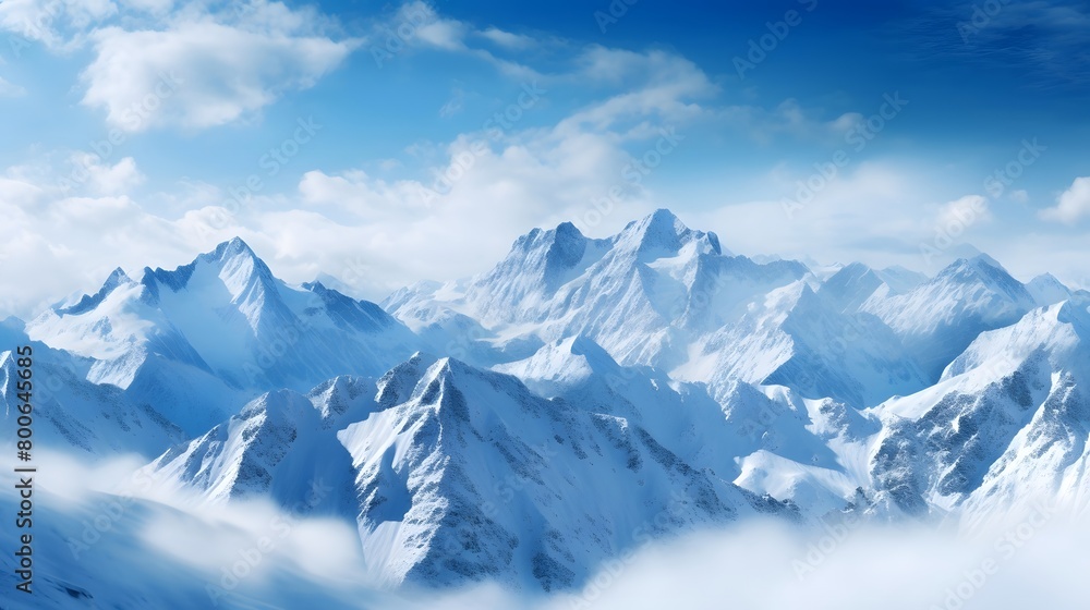 Panoramic view of the snowy mountains in the clouds. Panorama