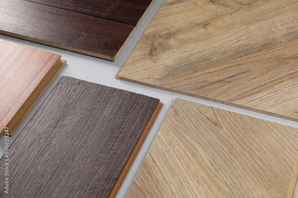 Fototapeta premium Different samples of wooden flooring on white background