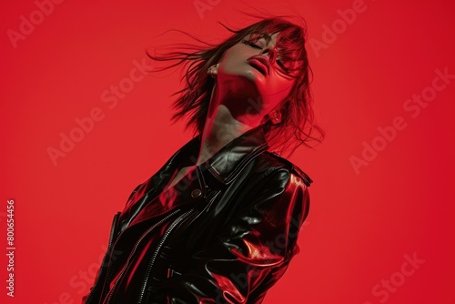 Stylish woman posing in a black leather jacket, suitable for fashion or lifestyle concepts