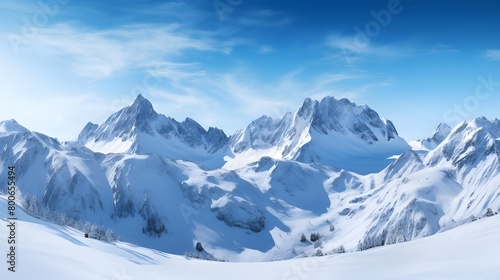 Panoramic view of snowy mountains and blue sky with clouds. © I