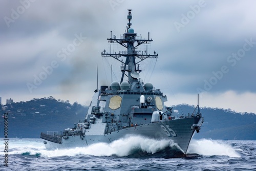 A navy ship sailing in the ocean on a cloudy day. Suitable for maritime themes