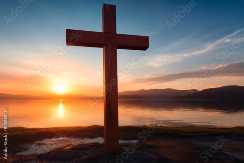 Serene sunset over a lake with a wooden cross