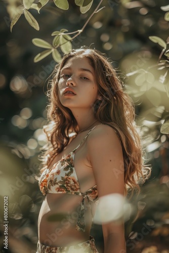 Beautiful caucasian young woman wearing a floral playsuit on sunny summer day photo