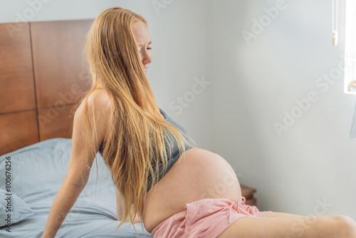 Expectant woman enters the labor phase, navigating the intense journey of childbirth with strength, resilience, and the anticipation of welcoming new life photo