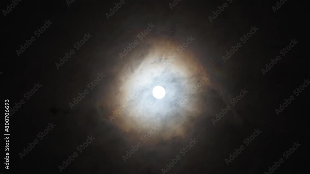 The moon between the movement of dark clouds The moon between the movement of dark clouds