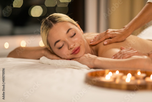 Woman Receiving Back Massage at Spa, Enjoying Relaxation