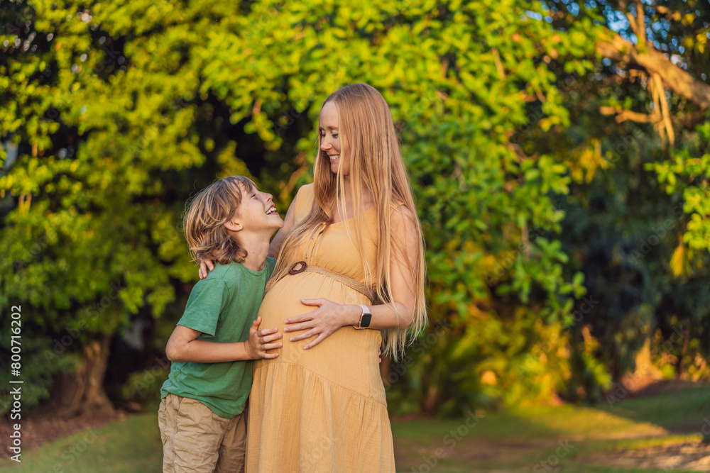 Fototapeta premium Heartwarming outdoor bonding as a pregnant mom and her son enjoy quality time together, savoring the beauty of nature and creating cherished moments