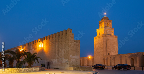 Night view of illuminated minaret of Great Mosque of Uqba in Tunisian city of Kairouan, Islamic heritage and oldest surviving Muslim minaret photo