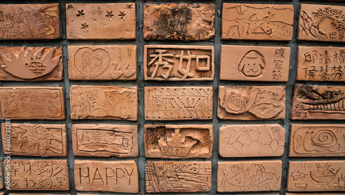 Carved handcrafted mud brick wall photo