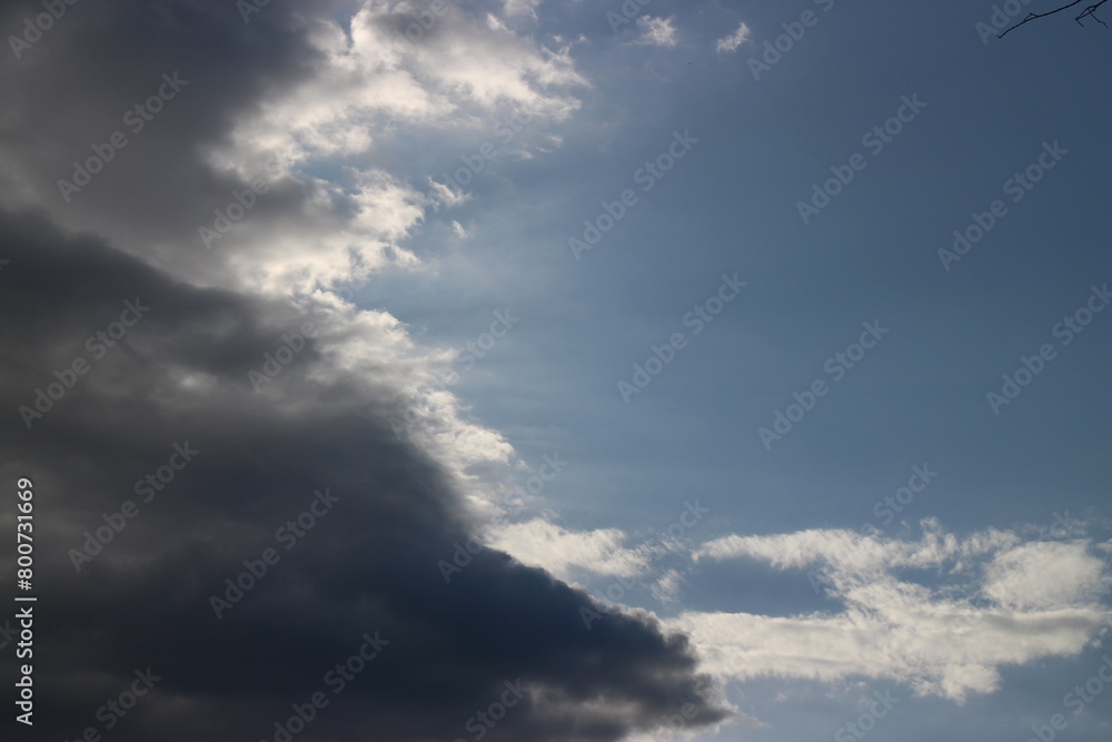 White grey cloudy day after rain with little bit ray of sun shining through the clouds, Sky nature background. White grey cloudy day after rain with little bit ray of sun shining through the clouds, Sky nature background.