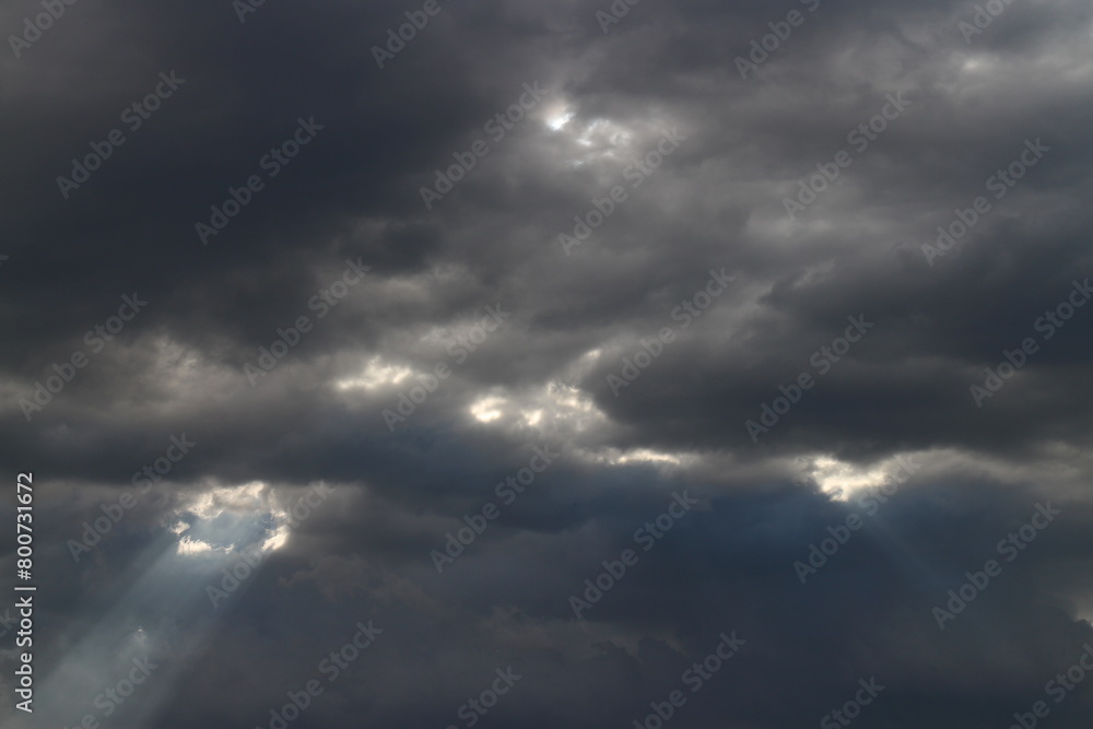 White grey cloudy day after rain with little bit ray of sun shining through the clouds, Sky nature background. White grey cloudy day after rain with little bit ray of sun shining through the clouds, Sky nature background.