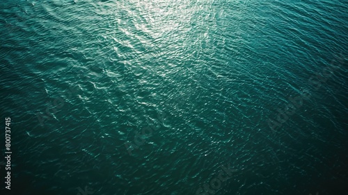 Sunlight shimmering on calm rippling ocean water