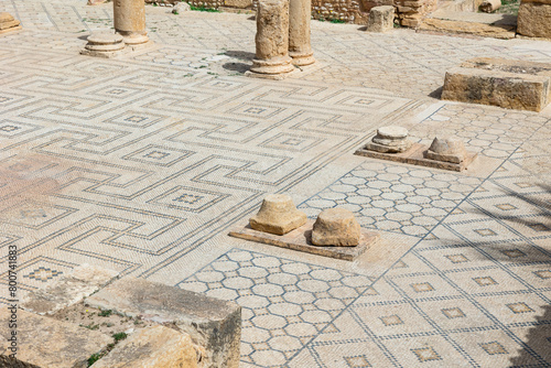Remains of ancient weathered stone columns rising from mosaic floors at ruins of Grand Baths of Sufetula on sunny spring day, Tunisia photo