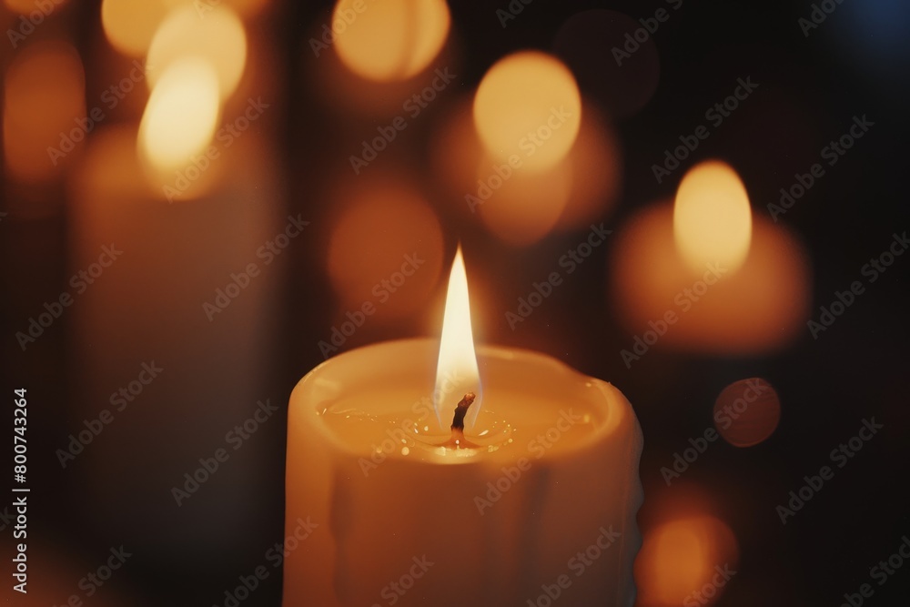 Lit candle on a dark background with bokeh Lit candle on a dark background with bokeh