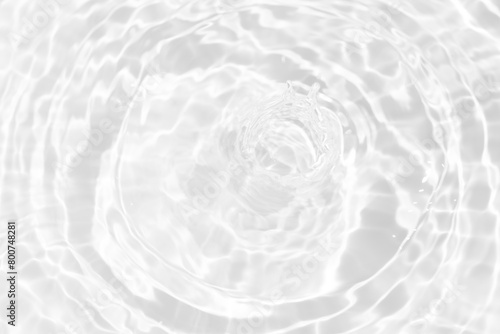 White water with ripples on the surface. Defocus blurred transparent white colored clear calm water surface texture with splashes and bubbles. Water waves with shining pattern texture background.