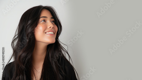 Malay woman wearing black criss cross dress smile isolated on gray