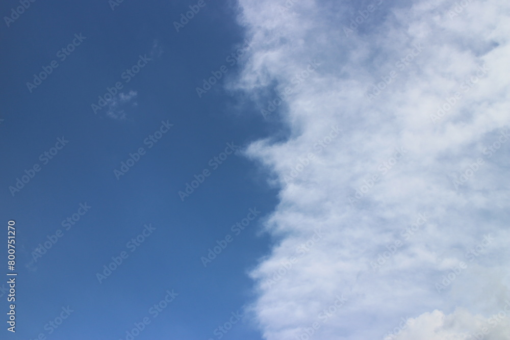 Fototapeta premium Blue sky with white clouds. Blue background. The summer sky is colorful clearing day and beautiful nature in the morning. for backdrop decorative and wallpaper design. The perfect sky background.
