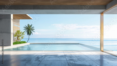 A large pool with a palm tree in the background. The pool is surrounded by a white wall and is located next to the ocean. The scene is serene and peaceful, with the water