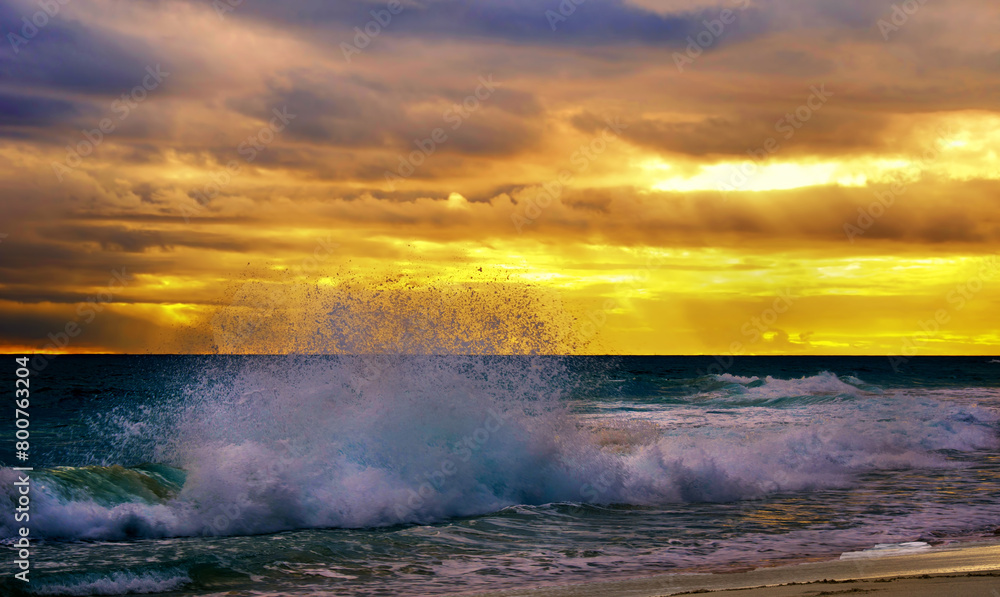 A large wave break close-up against a sunset