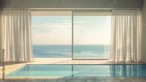A large window overlooking the ocean with white curtains. The curtains are open  allowing the sunlight to stream in and illuminate the room. The view of the ocean is serene and calming