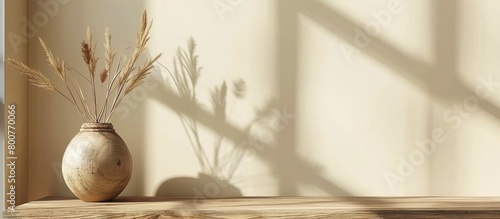Vase containing dried foliage placed on a wooden shelf in a room setting, adding a touch of nature indoors