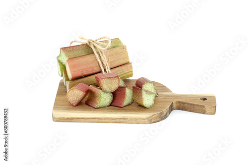 Rhubarb stalks of varying colors on wooden cutting board