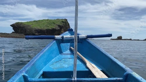 Boat sailing around the sea at Papuma Beach, Jember photo