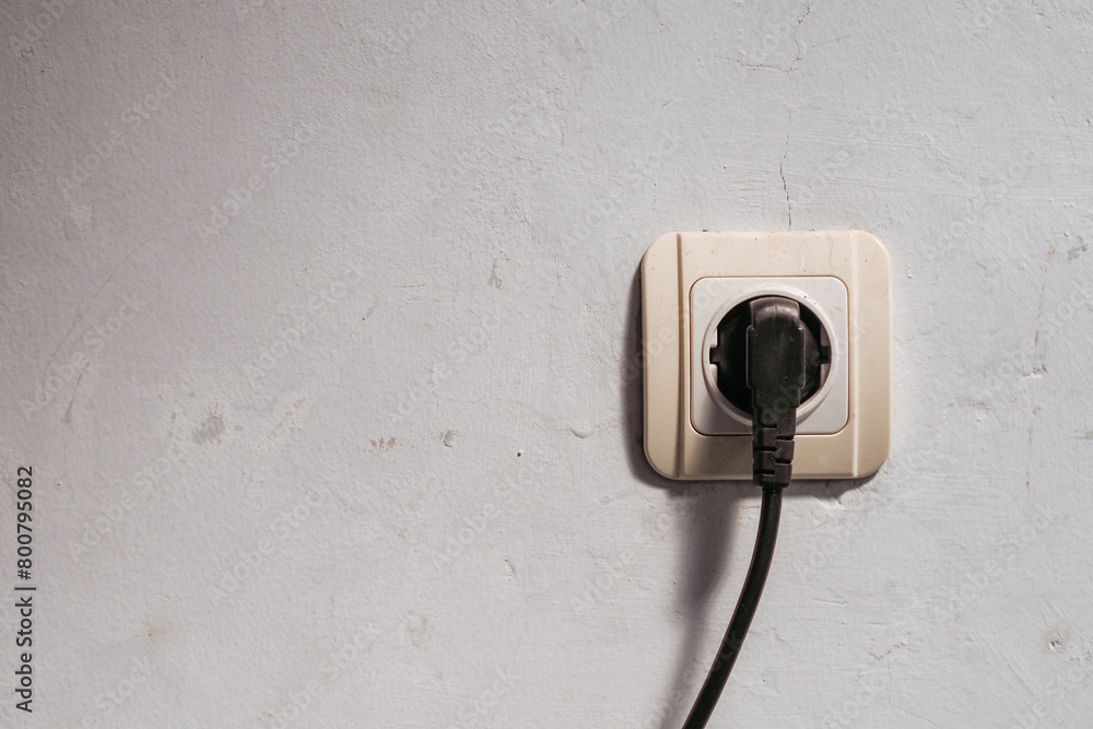 electrical plug in the wall that is being used electrical plug in the wall that is being used