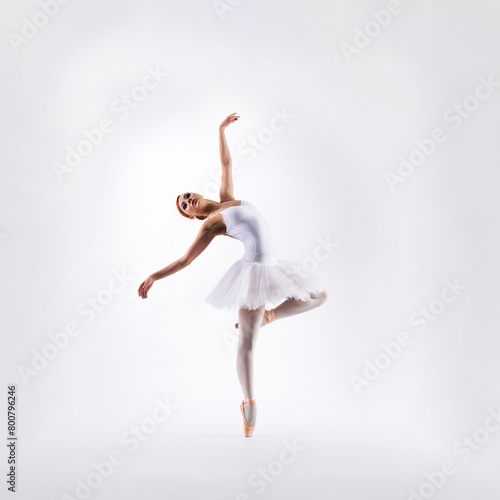 Ballet dancer isolated on white. Beautiful ballerina performing in studio.