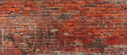 Close-up view of a textured brick wall with a red fire hydrant standing in front of it