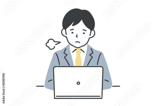 デスクワーク中にため息をつく男性