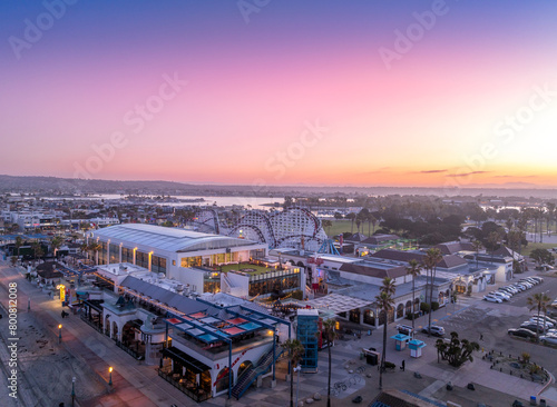 Aerial view of colorful sunrise sky over Mission Beach San Diego with Belmont Park Amusement park empty after a busy night