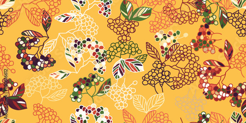 Inspired by the ecoregions natural environment, this seamless pattern features leaves and berries in shades of orange and yellow, perfect for textile art design photo