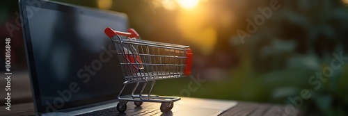Shopping online concept - Parcel or Paper cartons with a shopping cart logo in a trolley on a laptop keyboard. Shopping service on The online web. offers home delivery photo