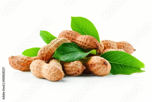 Brown peanuts with leaves on white background