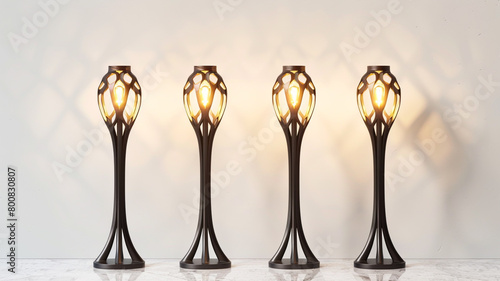 Four stylish ground lamps, radiating warmth and elegance, standing against a pure white surface