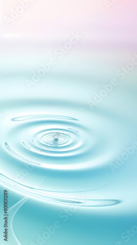 A drop of water falls on a calm surface and creates ripples